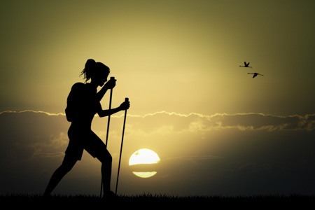 woman hiking at sunset