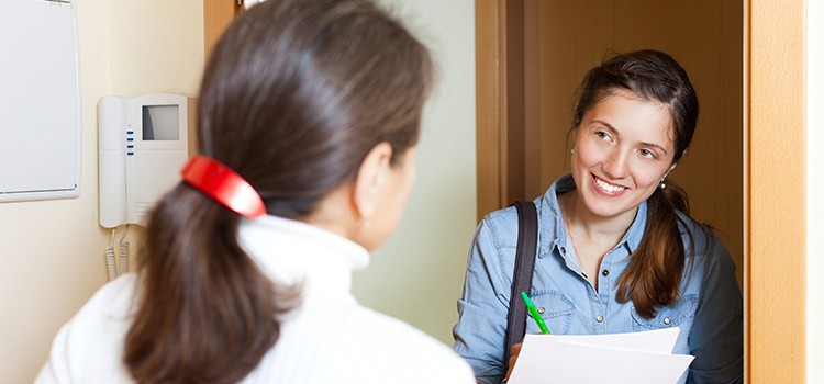 masters level social worker checks in with client at her apartment