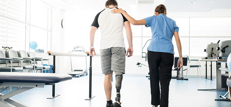 rehabilitation counselor walks and talks with rehabbing vet who lost leg