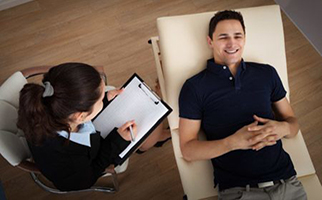 psychologist taking notes as patient talks