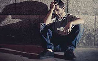 distraught man holds his head