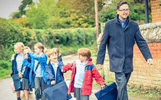 male teacher leads group of kids