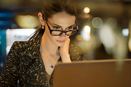 woman researching on her laptop