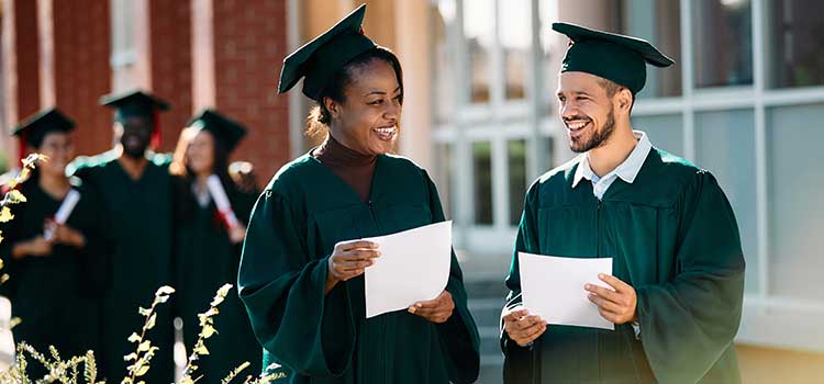 two masters students hold degree completion letters