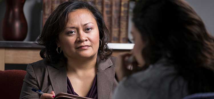 serious therapist listens intently to client talk