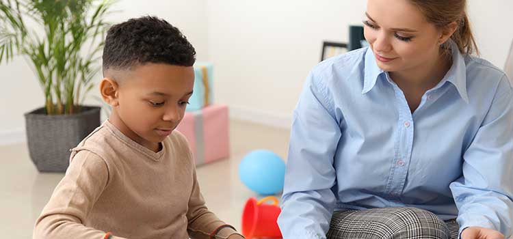 school counselor works with young boy during session