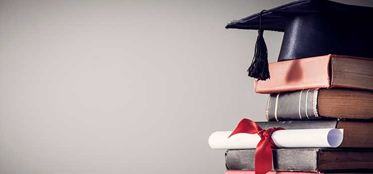 college degree mortarboard on stack of books