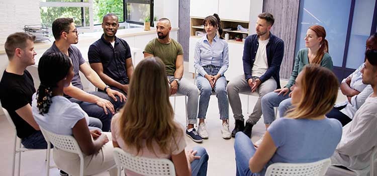 counselor leads group therapy session