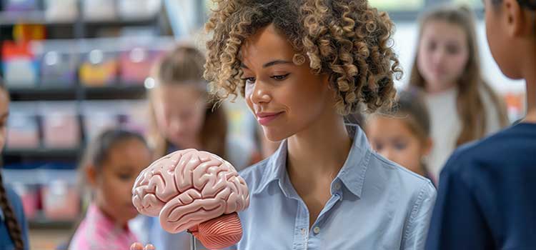 female teacher explains brain and development function to class of young students