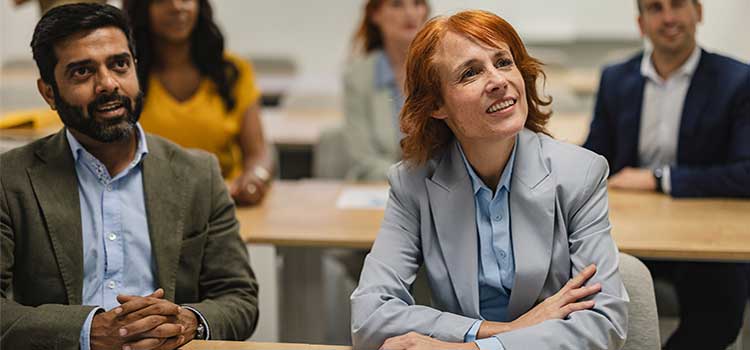 two research psychologists participate in group discussion over data findings