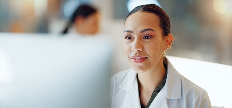 research psychologist examines laptop screen for consumer behavior data